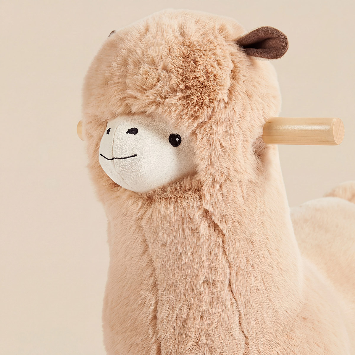Close-up of fluffy llama rocker face with soft plush texture